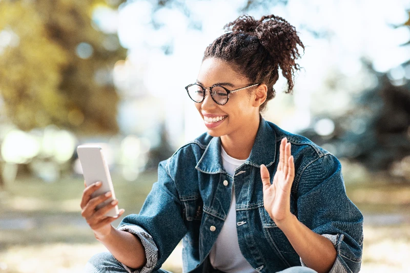 Happy woman using smartphone making a video call