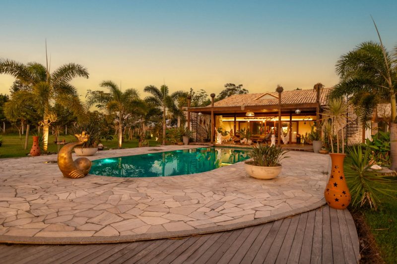 Tranquil backyard with a pool palm trees and a cozy house at 1776790857